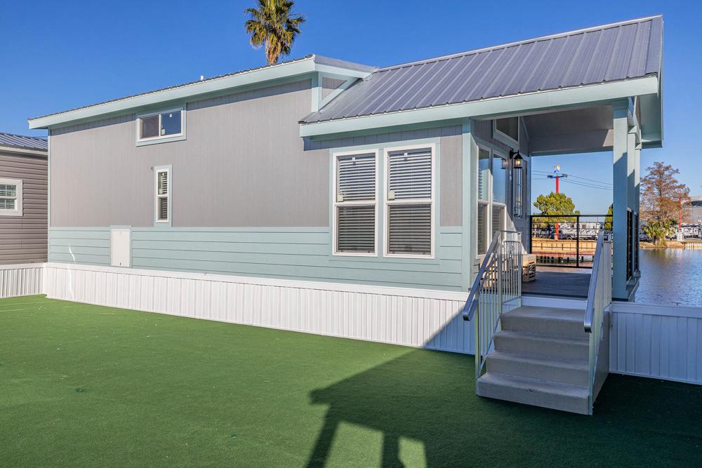 Tiny home as ADU placed on residential lot with primary home in background